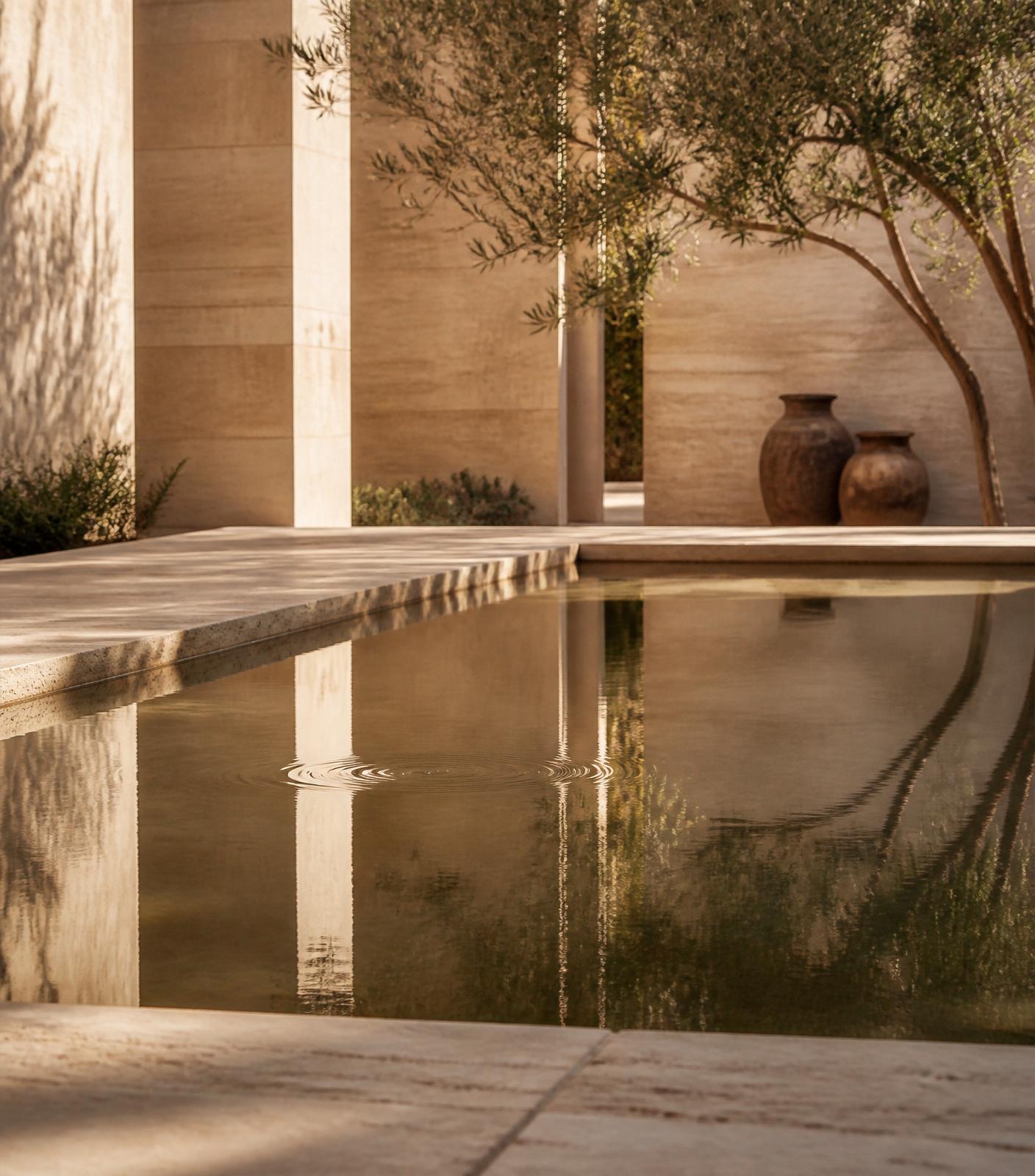 A still stone water feature in the courtyard